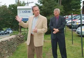 Astor Board Chair Larry Weisberg addresses the crowd as Dr. Jim McGuirk Looks On