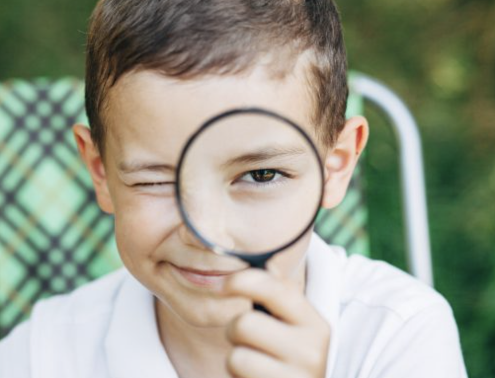 boy with magnifying glass